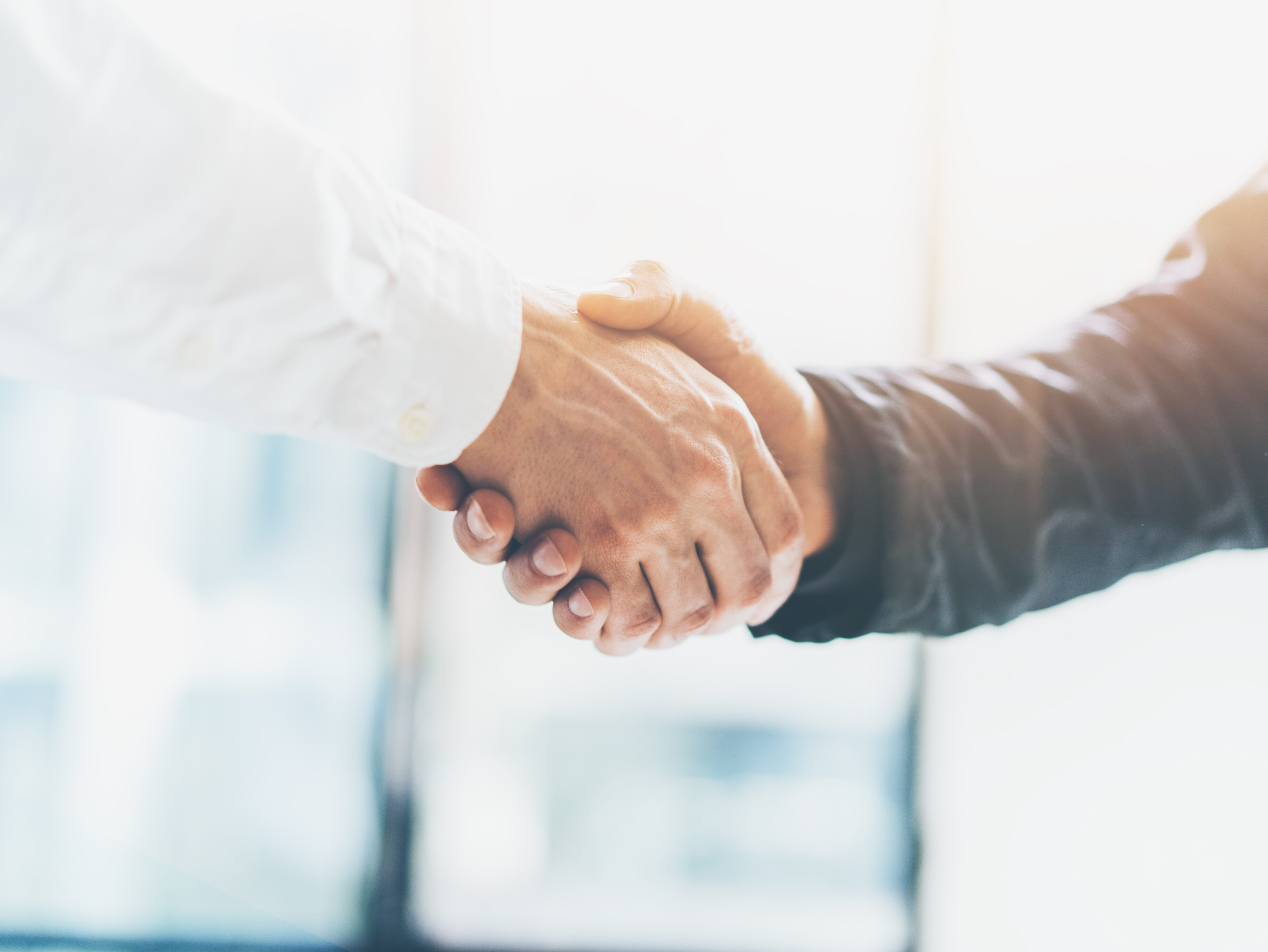 Business partnership meeting. Picture businessmans handshake. Successful businessmen handshaking after good deal. Horizontal, blurred background